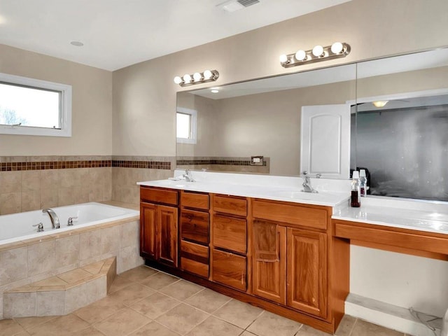 bathroom with tile patterned flooring, vanity, and a wealth of natural light