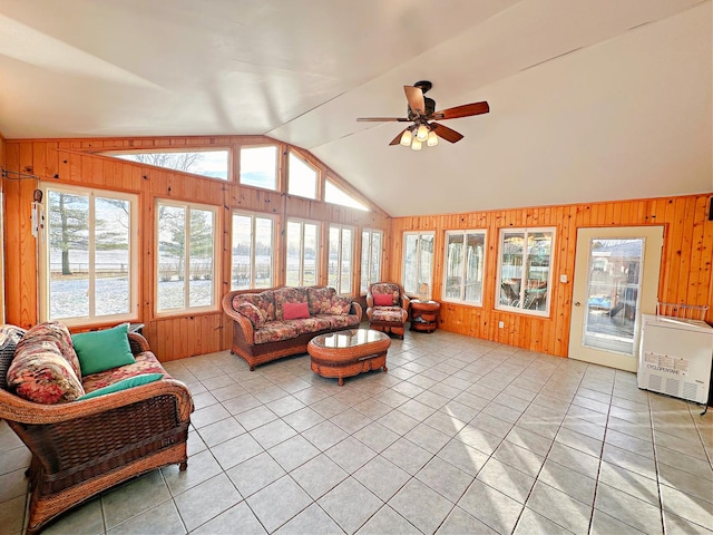 sunroom / solarium featuring heating unit, vaulted ceiling, and ceiling fan