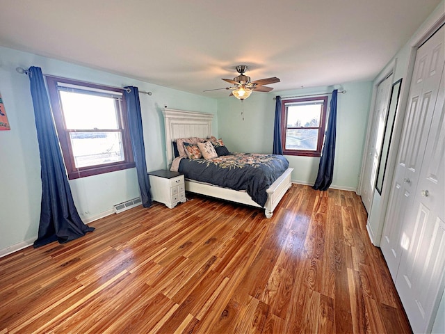 bedroom featuring ceiling fan, a closet, and hardwood / wood-style flooring