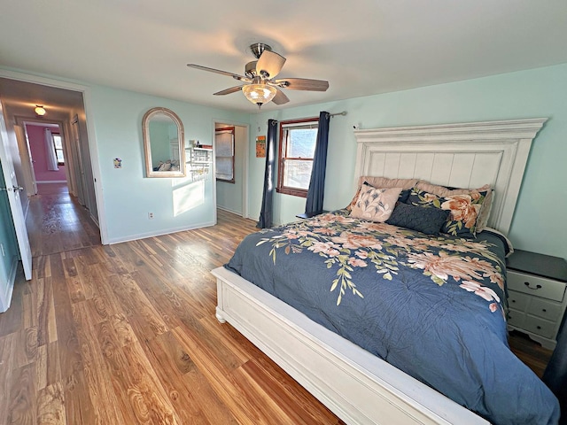 bedroom with ceiling fan and wood-type flooring