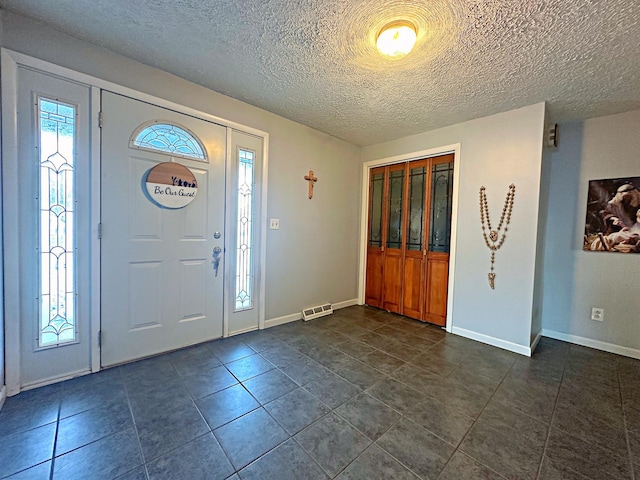 foyer entrance featuring a healthy amount of sunlight and a textured ceiling