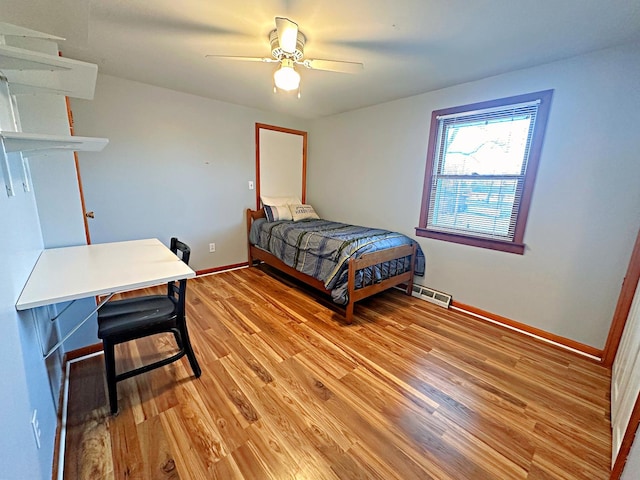 bedroom with ceiling fan and wood-type flooring