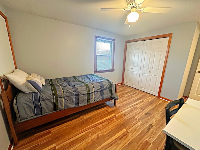 bedroom with ceiling fan, light hardwood / wood-style floors, and a closet