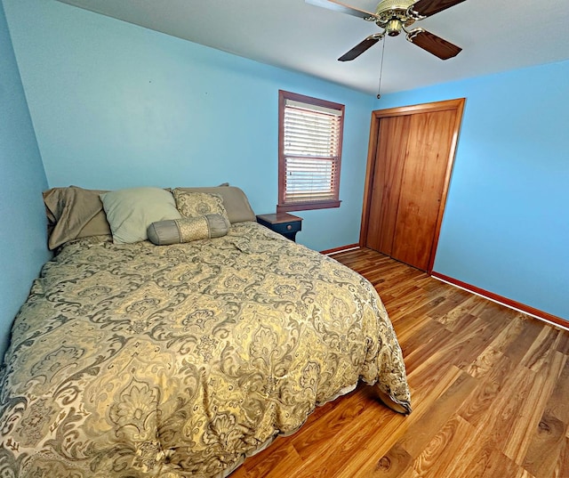 bedroom with ceiling fan and wood-type flooring