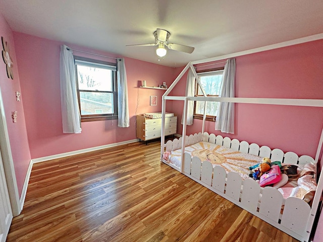 bedroom with hardwood / wood-style flooring and ceiling fan