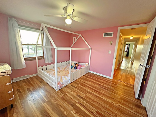 unfurnished bedroom with hardwood / wood-style floors and ceiling fan