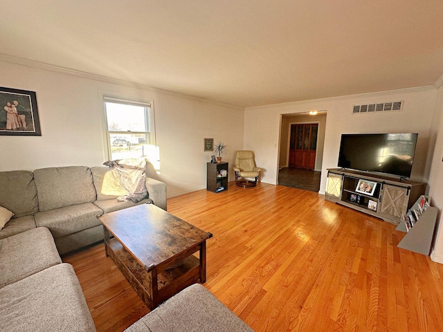 living room with crown molding and wood-type flooring