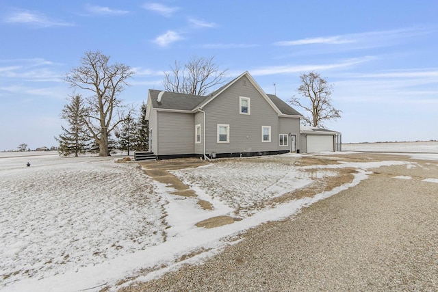 snow covered property with a garage