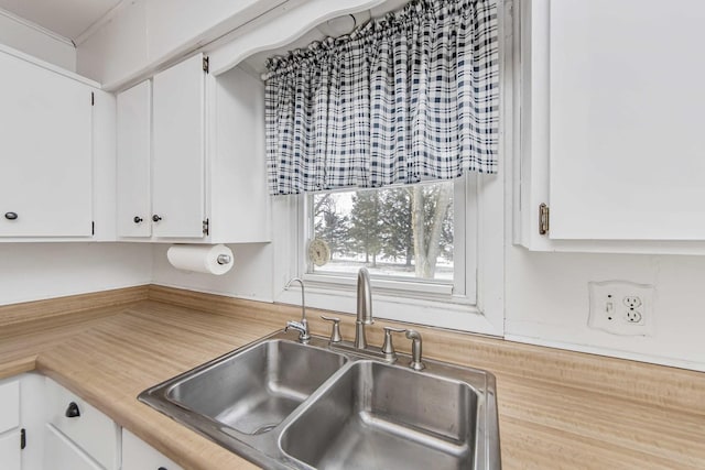 kitchen with sink and white cabinetry
