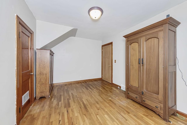 additional living space with light hardwood / wood-style floors