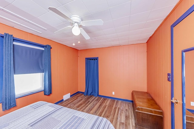 bedroom with ceiling fan and light hardwood / wood-style floors