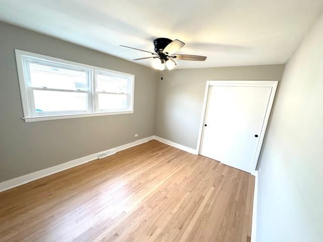 unfurnished bedroom with ceiling fan, a closet, and light hardwood / wood-style flooring