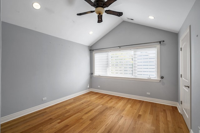 spare room featuring ceiling fan, lofted ceiling, and light hardwood / wood-style flooring