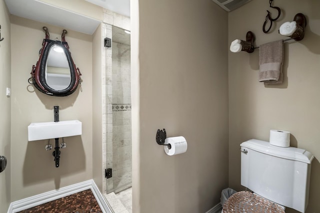 bathroom with toilet, sink, and walk in shower