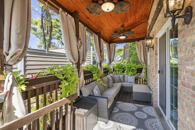 wooden terrace with a porch and ceiling fan