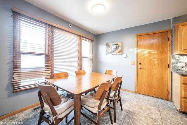 dining space featuring light tile patterned floors