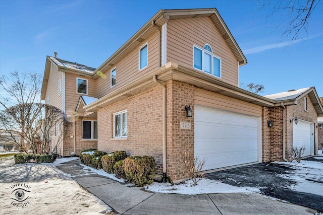 view of snow covered exterior with a garage