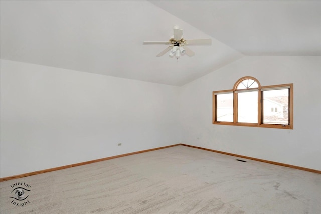 carpeted empty room with vaulted ceiling and ceiling fan