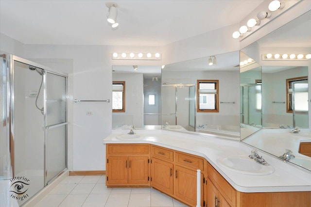 bathroom with a shower with door, vanity, and tile patterned flooring