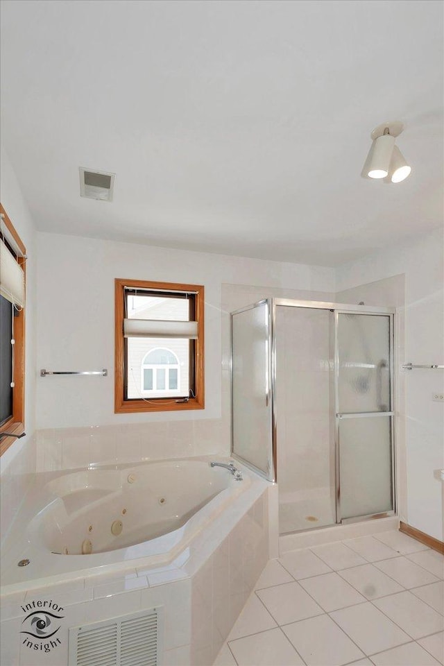 bathroom with independent shower and bath and tile patterned flooring