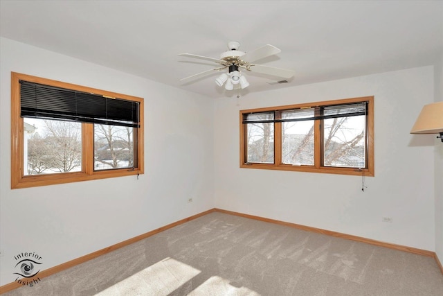 unfurnished room featuring ceiling fan, carpet, and a healthy amount of sunlight