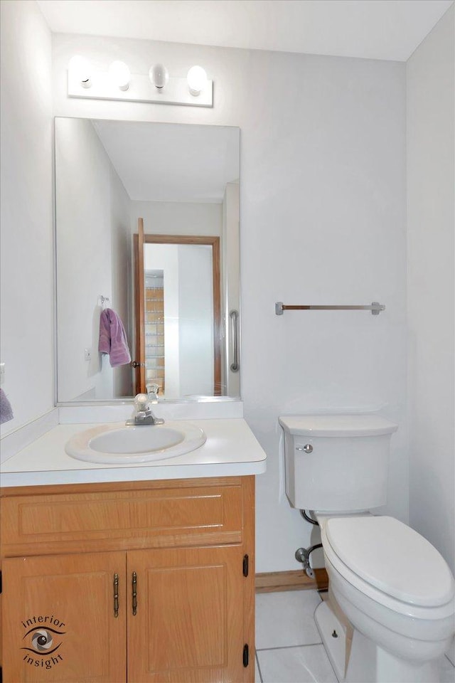 bathroom featuring toilet, tile patterned floors, and vanity