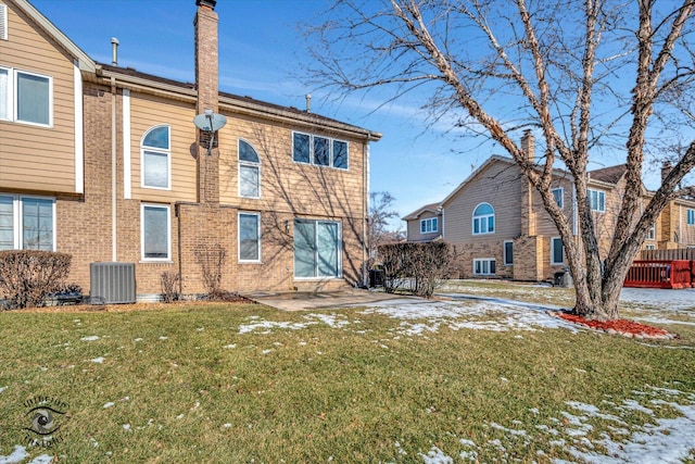 back of property with a patio area, central air condition unit, and a lawn