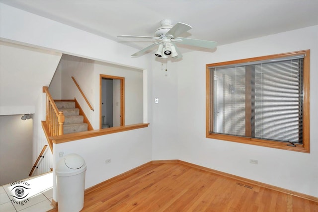 spare room with ceiling fan and light wood-type flooring