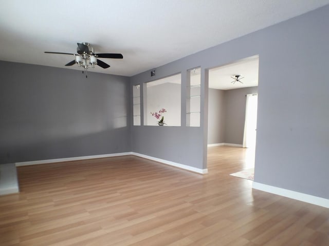 unfurnished room featuring ceiling fan and light hardwood / wood-style floors