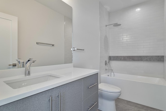 full bathroom featuring vanity, toilet, and tiled shower / bath