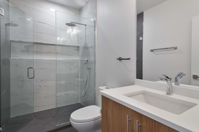 bathroom featuring vanity, an enclosed shower, and toilet