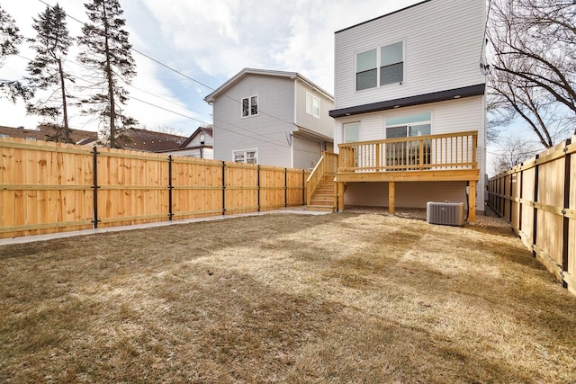 rear view of house featuring central air condition unit and a wooden deck