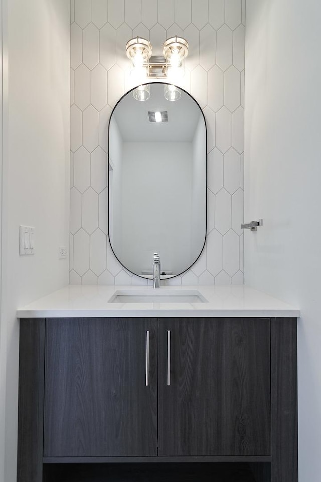 bathroom featuring vanity and tile walls