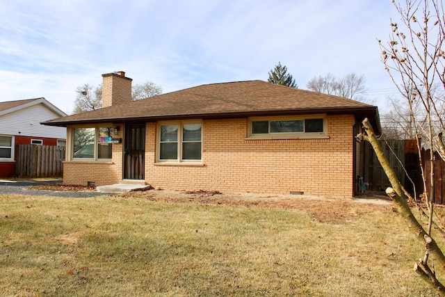 rear view of property with a lawn