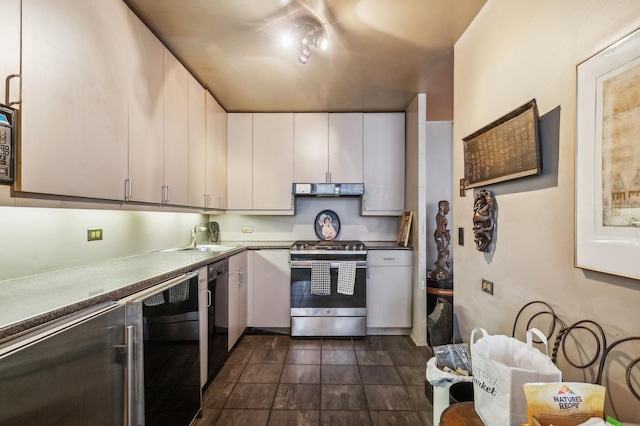 kitchen featuring sink, dishwasher, stainless steel gas range, and white cabinetry