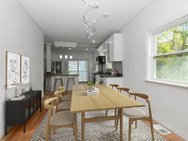 dining area featuring light wood-type flooring