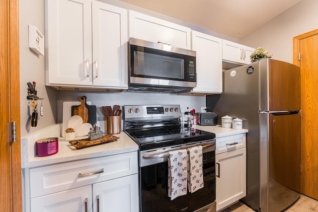 kitchen with white cabinets and appliances with stainless steel finishes