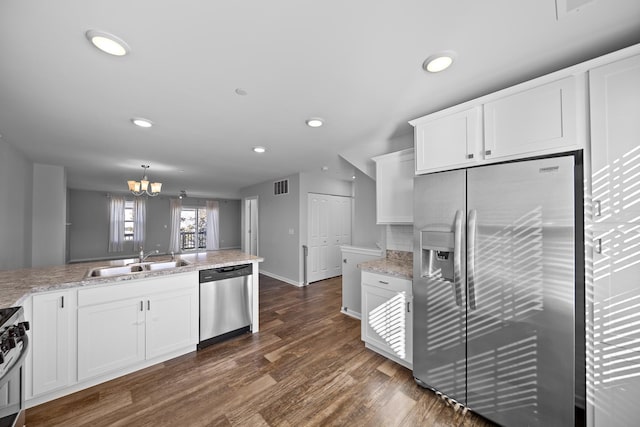 kitchen featuring dark wood-type flooring, sink, white cabinets, and stainless steel appliances