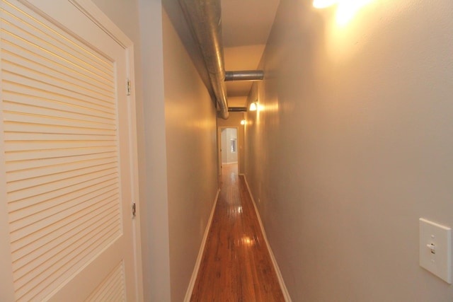 hallway with hardwood / wood-style flooring