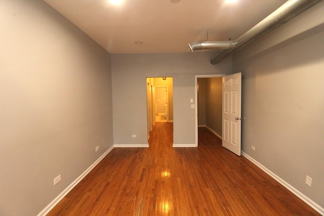 unfurnished bedroom with dark hardwood / wood-style floors