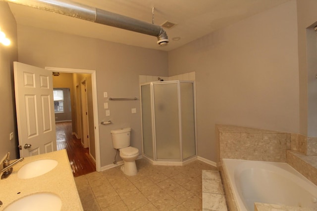 full bathroom featuring shower with separate bathtub, vanity, and toilet