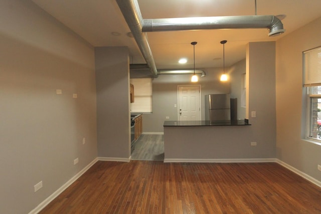 unfurnished living room featuring dark hardwood / wood-style floors