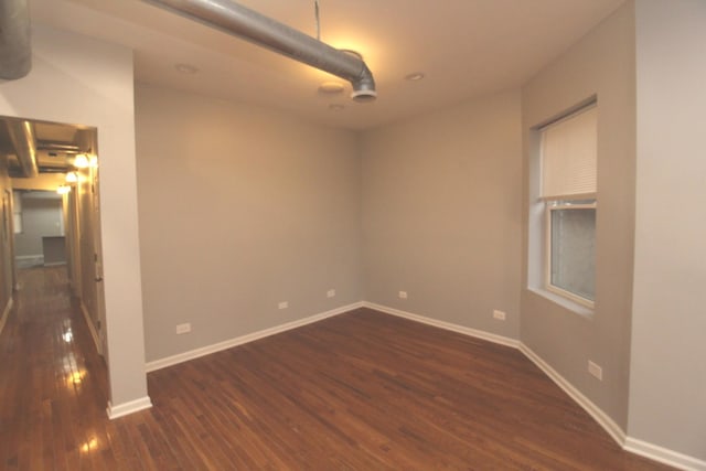 empty room featuring dark hardwood / wood-style flooring