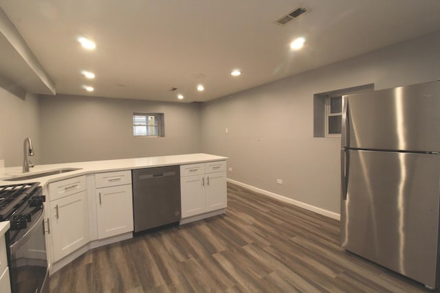 kitchen featuring sink, stainless steel refrigerator, white cabinetry, black dishwasher, and gas range