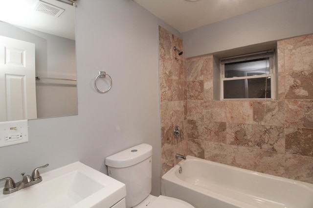 full bathroom with vanity, toilet, and tiled shower / bath