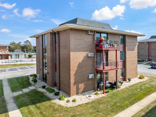 exterior space with a yard and a balcony