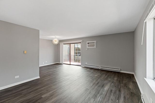 empty room featuring a chandelier, dark wood-type flooring, a wall mounted AC, and a baseboard heating unit