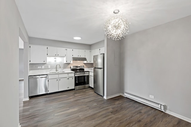 kitchen with sink, hanging light fixtures, stainless steel appliances, an inviting chandelier, and a baseboard heating unit