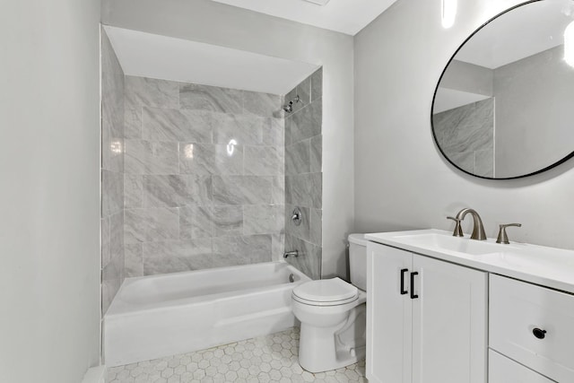 full bathroom featuring toilet, tile patterned flooring, vanity, and tiled shower / bath