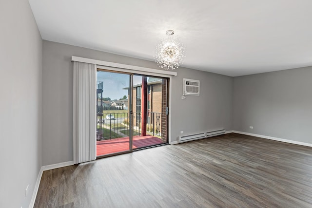 spare room featuring a baseboard radiator, an inviting chandelier, a wall mounted AC, and dark wood-type flooring